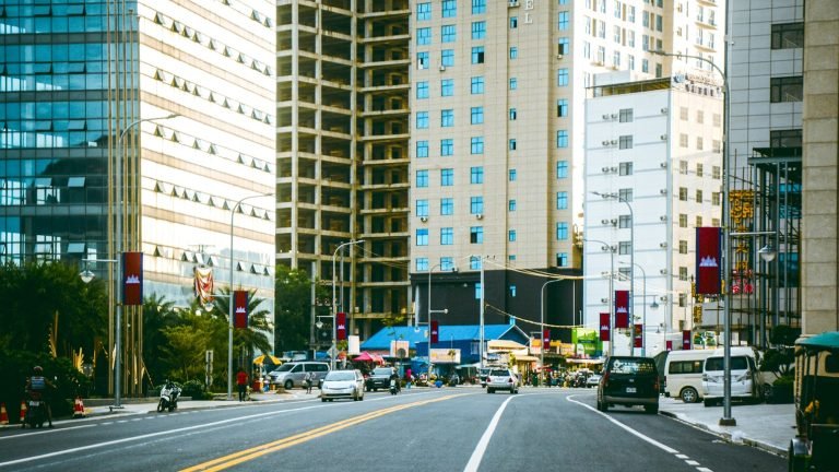 Sihanoukville Cambodia city street with modern buildings, traffic, and high-rise construction Caption: Description: