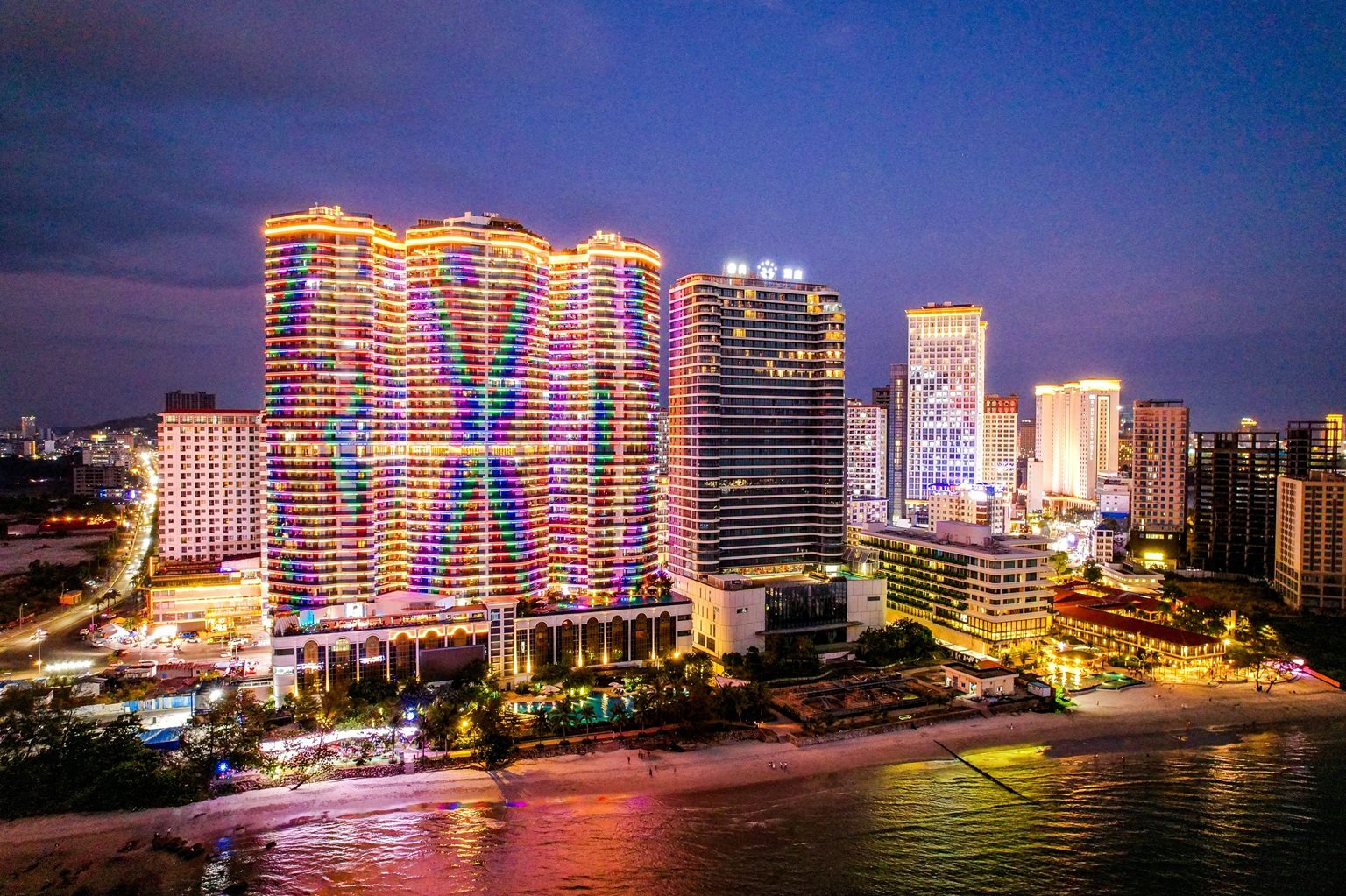 Sihanoukville Cambodia skyline at night with illuminated high-rise buildings along the beachfront