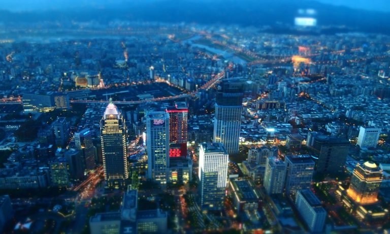 Is Taiwan safe Taipei skyline at night with illuminated buildings and busy city streets