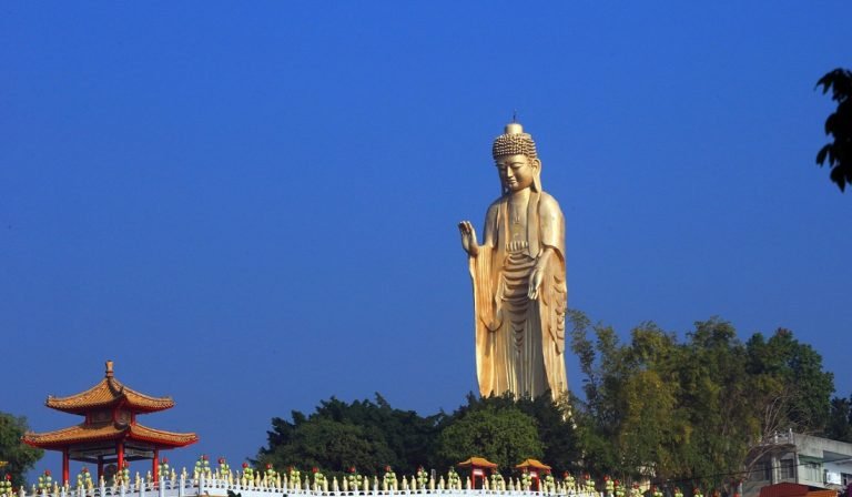 Taiwan SIM vs eSIM comparison with Buddha statue and temple landscape in Taiwan