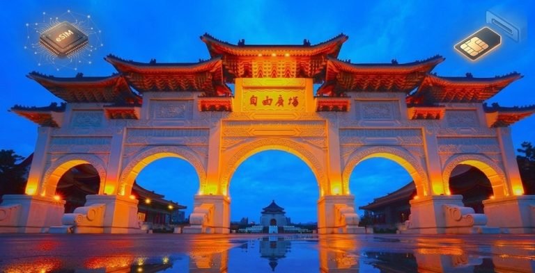 Taiwan SIM vs eSIM comparison with illuminated Taipei gate and reflection at night