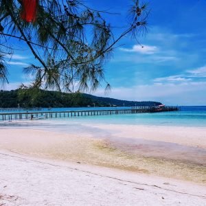 Koh rong samloem beach with white sand, turquoise water, and wooden pier stretching into the sea