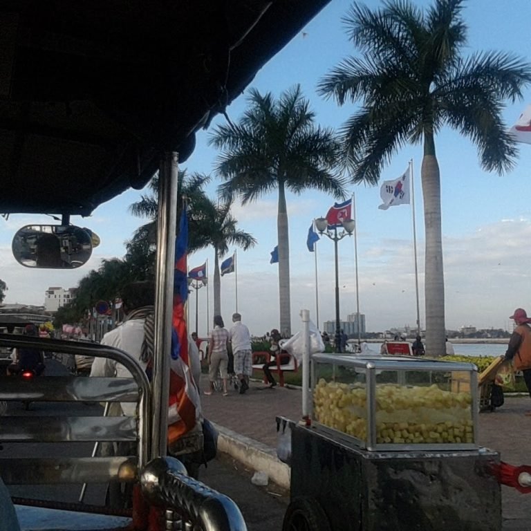 Getting around Cambodia by tuk-tuk along Phnom Penh riverside promenade