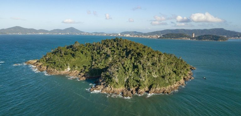 Aerial view of a lush tropical island surrounded by ocean, representing the best islands in Brazil Caption Description