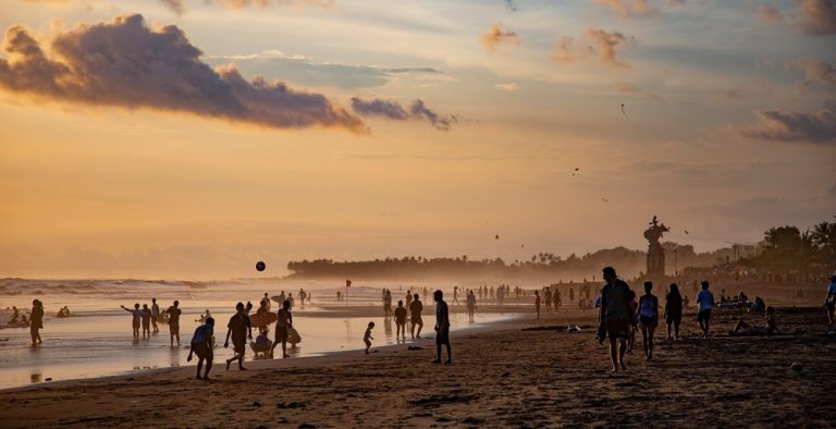 Bali travel cost guide showing visitors enjoying sunset on a popular beach in Bali, Indonesia Caption: Description: