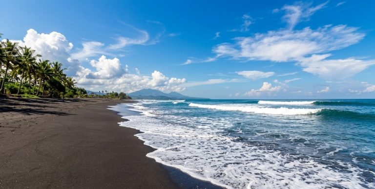 Black volcanic sand and rolling surf at Keramas Beach on Bali’s eastern coastline