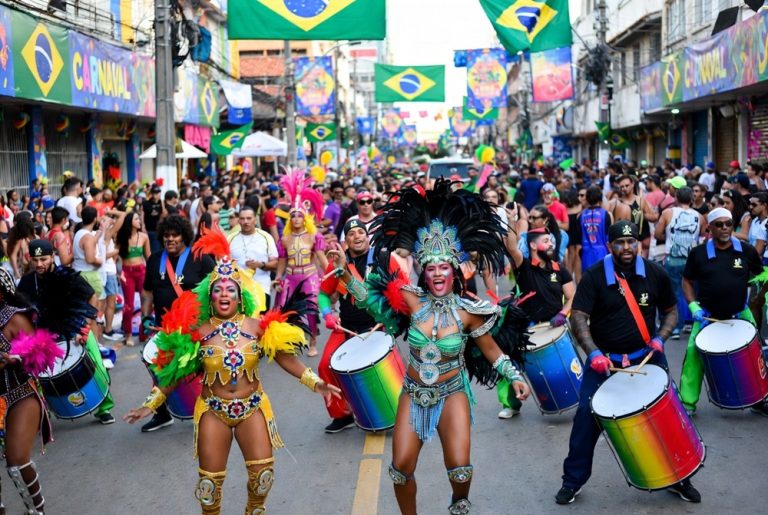 Brazil Carnival street bloco with samba drummers, dancers, and crowds celebrating during Carnival in Brazil