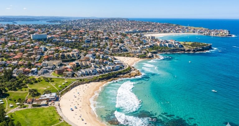 Aerial view of Bronte Beach, one of the most scenic beaches in Sydney with turquoise water and coastal cliffs