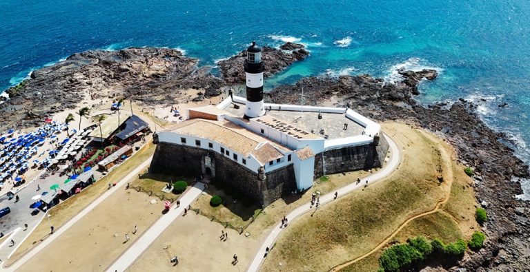 Farol da Barra lighthouse and coastline showing where to stay in Salvador, Brazil