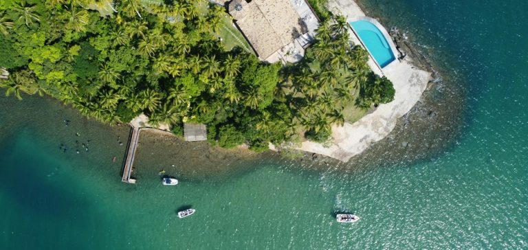 Aerial view of a tropical island retreat and turquoise coastline among the best islands in Brazil Caption Description