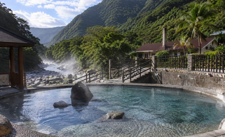 Taiwan hot springs at a mountain resort with outdoor geothermal pools, riverside scenery, and lush green valley landscape