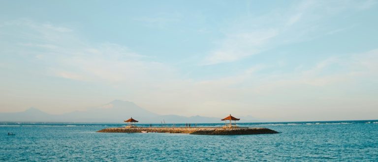 Traditional gazebos overlooking the calm ocean waters in Sanur, Bali Caption: Description: