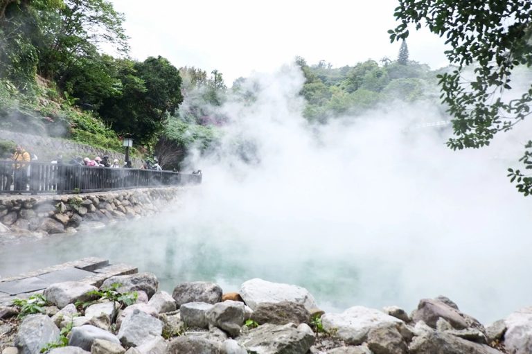 Taiwan hot springs at Beitou with heavy geothermal steam, rocky shoreline, and volcanic sulfur pools near Taipei