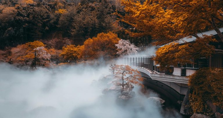 Steaming hot spring landscape surrounded by autumn trees in northern Taiwan Caption: Description: