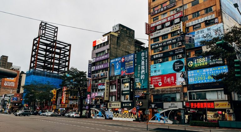 Busy commercial streets and buildings in Taipei’s Gongguan district during the day Caption: Description: