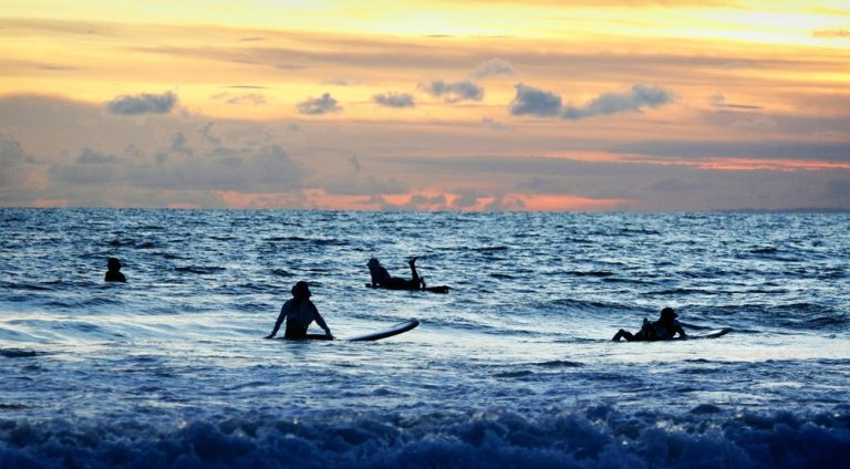 Surfers waiting for waves during sunset in Kuta, Bali Caption: Description: