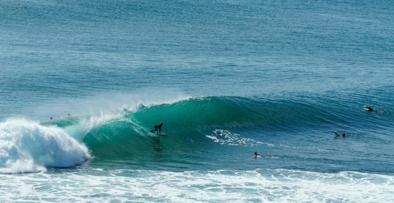 Surfer riding a powerful turquoise wave off the coast of Bali Caption: Description: