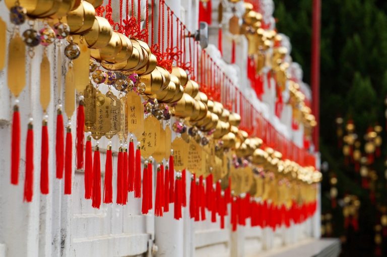 Traditional prayer bells and red tassels at a Taiwanese temple - Taiwan travel budget guide Caption: Description: