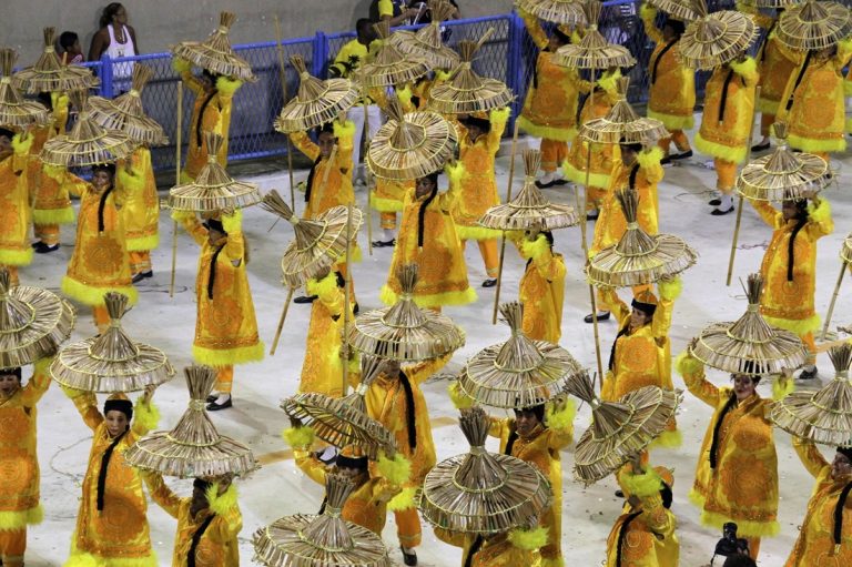 Brazil Carnival parade wing performing in coordinated traditional costumes during a Rio samba school parade