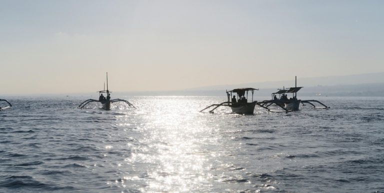 Traditional fishing boats at sunrise during a Bali itinerary exploring Bali’s coastline and island life