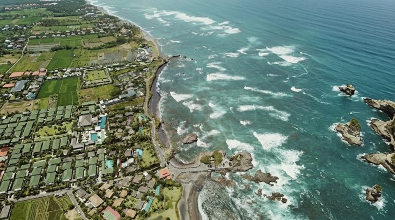 Canggu travel guide aerial view of Bali's southwest coastline with beaches, surf breaks, resorts, and tropical scenery
