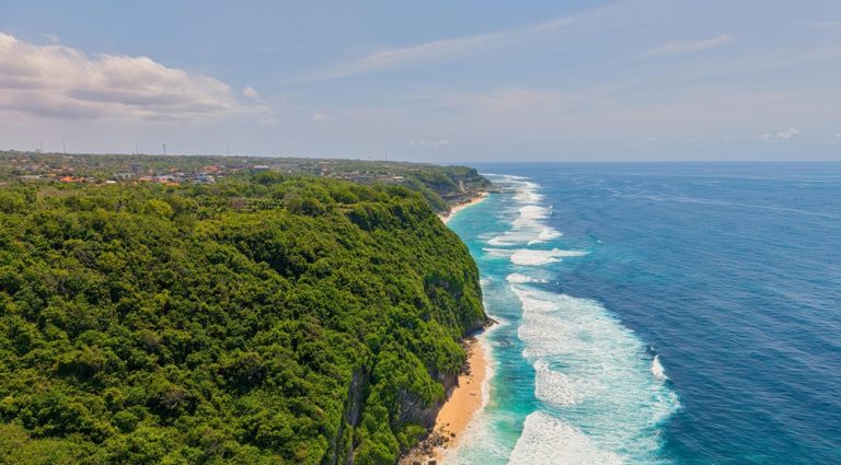 Aerial view of Uluwatu's limestone cliffs and turquoise coastline featured in this Uluwatu travel guide Caption: Description: