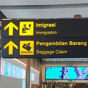 Bali airport guide showing immigration and baggage claim signs inside Ngurah Rai International Airport