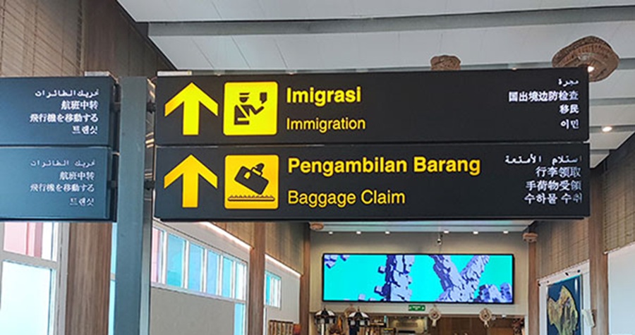 Bali airport guide showing immigration and baggage claim signs inside Ngurah Rai International Airport