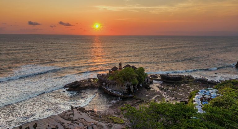 Bali belly travel guide featuring Tanah Lot temple and Bali coastline at sunset
