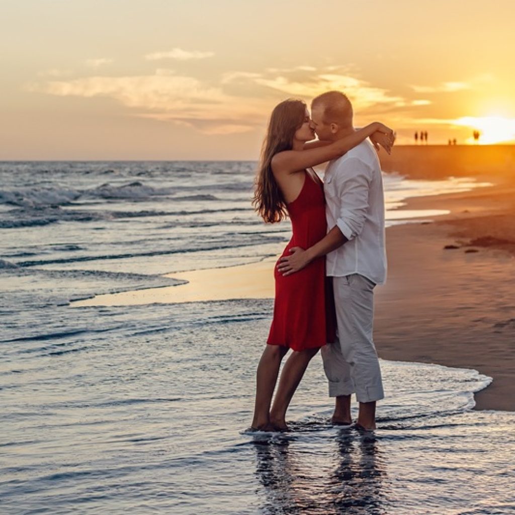 Couple enjoying a sunset walk on the beach in Bali - Bali honeymoon guide