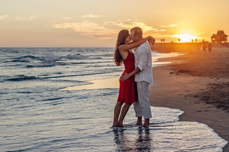 Couple enjoying a sunset walk on the beach in Bali - Bali honeymoon guide
