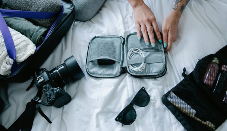 Bali packing list essentials including travel electronics chargers camera accessories and organized luggage for a Bali trip Caption Description