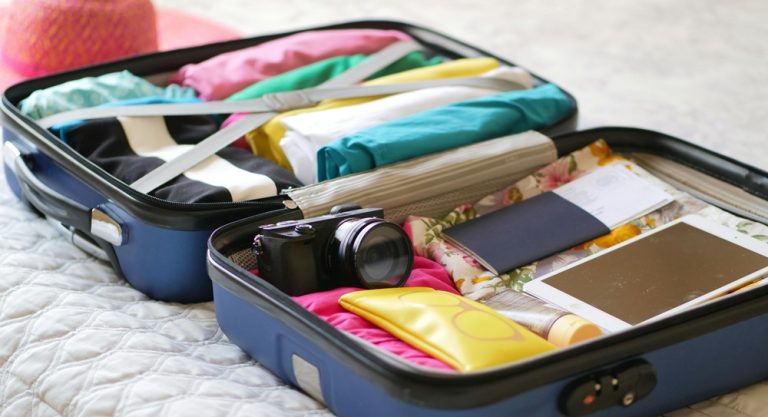 Bali packing list essentials including clothes electronics travel documents and toiletries packed inside a suitcase