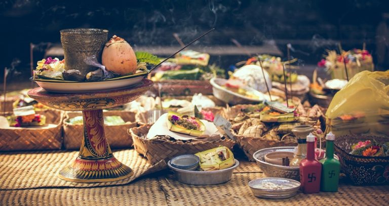 Food in Bali and Balinese cultural offerings displayed during a traditional Hindu ceremony on the island
