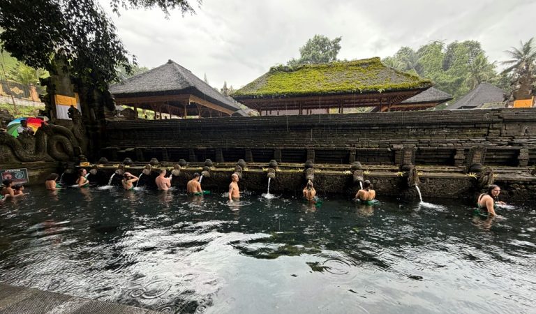best temples in bali featuring visitors taking part in purification rituals at Tirta Empul Temple Caption: Description: