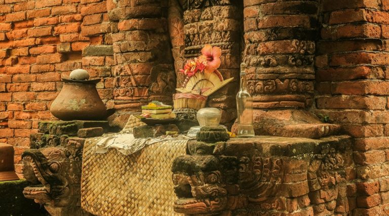 best temples in bali featuring traditional Hindu offerings at a sacred temple shrine Caption: Description: