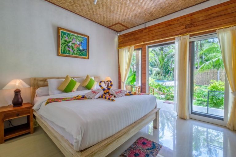 Spacious room at Crystal Bay Bungalows in Nusa Penida with a king-size bed, tropical décor, and garden views Caption: Description: