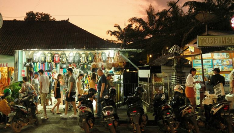 Visitors exploring shops and local businesses near Seminyak Village during the evening in Bali