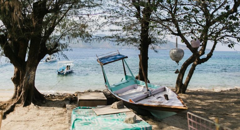 Day trips from Bali to the Gili Islands featuring tropical beaches, clear water, and traditional island boats Caption Description