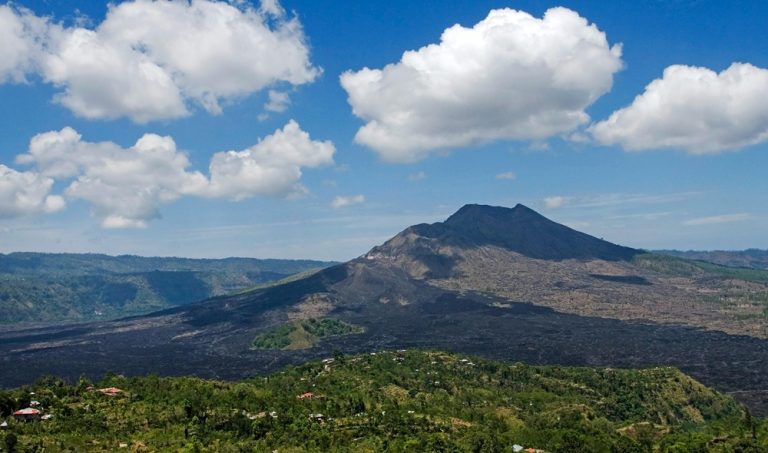 Day trips from Bali featuring Mount Batur volcano and the surrounding volcanic landscape Caption Description