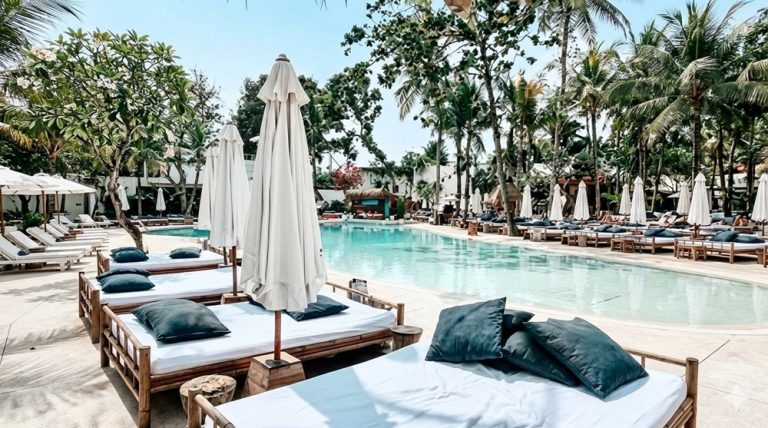 Visitors relaxing beside the pool at Mrs Sippy Bali in Seminyak