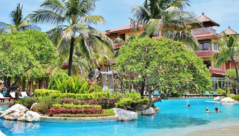 Tropical resort in this Nusa Penida travel guide featuring palm trees, swimming pool, and accommodation options on Nusa Penida Island