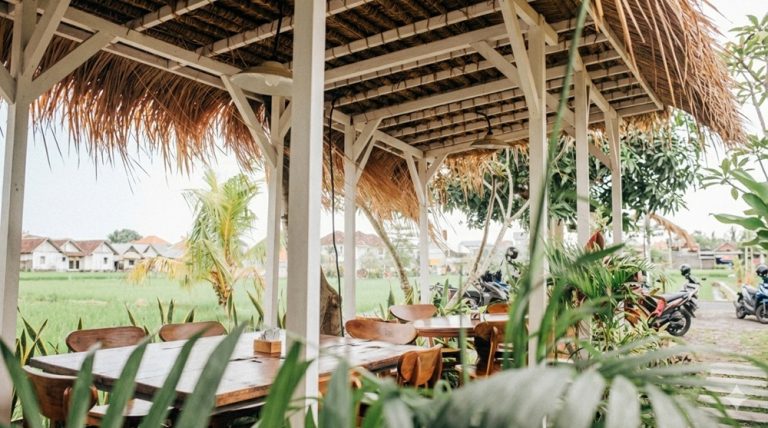 Open-air café overlooking rice fields and tropical countryside in Bali