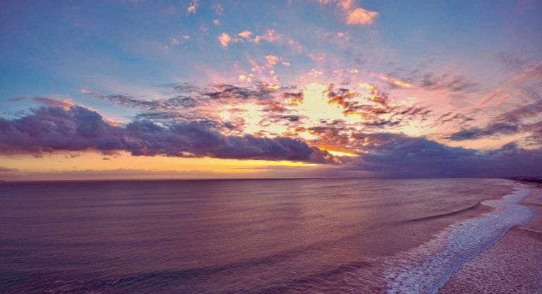 Seminyak travel guide featuring a colorful sunset over Seminyak Beach and the Indian Ocean in Bali