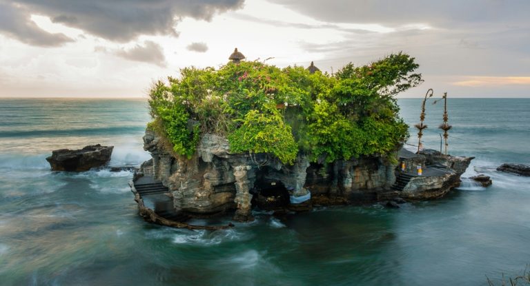 Tanah Lot Temple perched on a rocky offshore island surrounded by the ocean in Bali, Indonesia