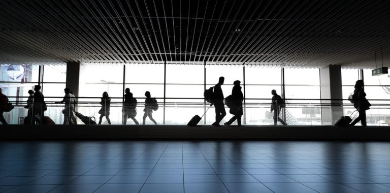 Bali Airport Guide: travelers walking through the departure terminal at Ngurah Rai International Airport