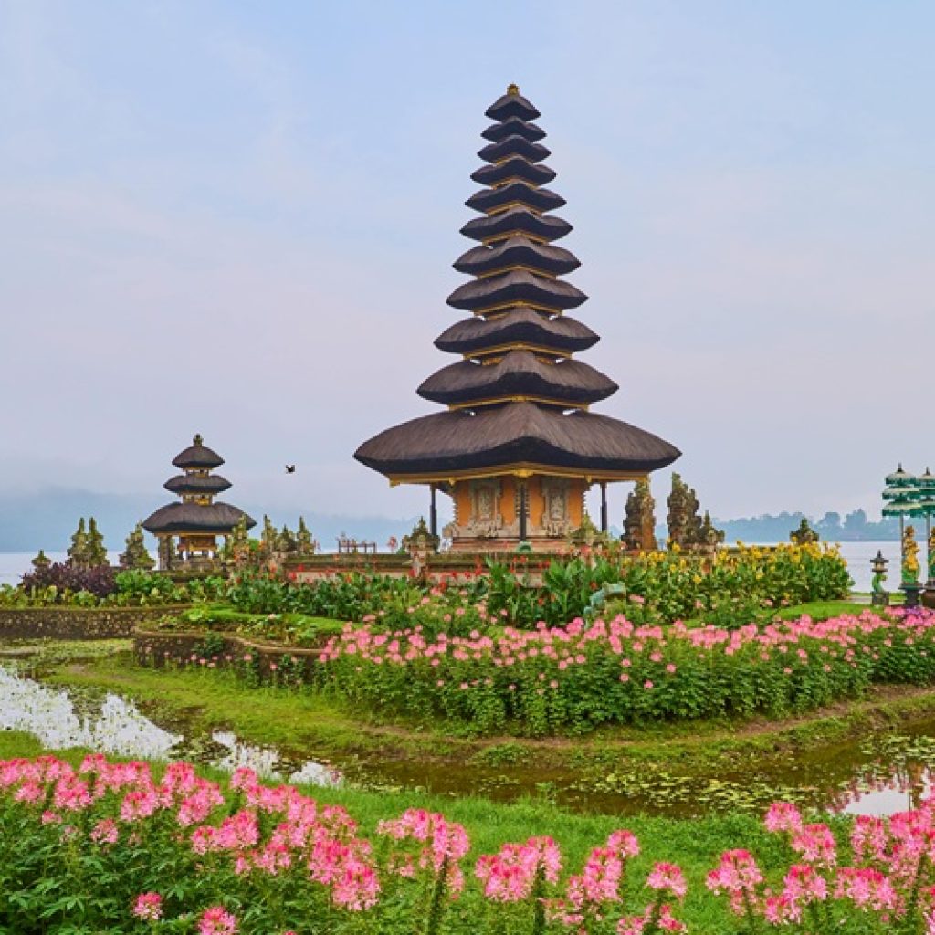 Best areas to stay in Bali guide featuring Ulun Danu Beratan Temple on Lake Beratan surrounded by colorful flowers