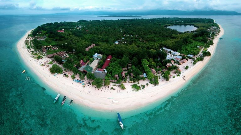 Aerial view of Gili Meno surrounded by white-sand beaches, turquoise lagoons, coral reefs and crystal-clear waters.