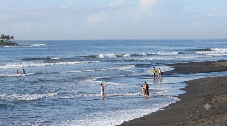 Keramas Beach in Bali with surfers and gentle waves, featured in this Bali surf guide.