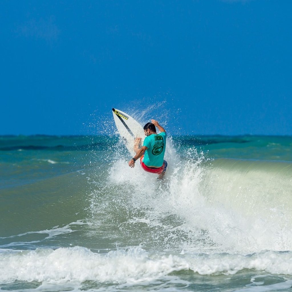 Surfer carving across a breaking wave in Bali, Indonesia, featured in this Bali surf guide.